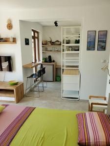 a living room with a green bed and a kitchen at Obzor Tatyana Apartaments Natura in Obzor