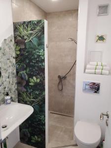 a bathroom with a shower and a toilet and a sink at Obzor Tatyana Apartaments Natura in Obzor