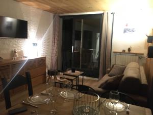 a living room with a table and a couch at Les Deux Alpes, Le Lauvitel, appartement cosy, pied des pistes, 2 adultes 2 enfants in Les Deux Alpes