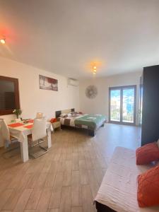 a living room with a bed and a table at Apartments Darija in Kotor