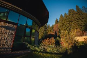 a building with glass windows on the side of it at Denisa Boutique in Poiana Brasov