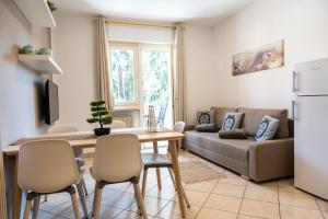 a kitchen and living room with a table and a couch at Flow Apartments Wolkenstein in Merano