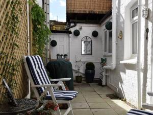 a pair of chairs sitting on a patio in an alley at Decimus in St. Leonards