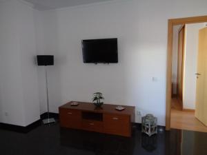 a living room with a flat screen tv on the wall at Rochatower Apartment 8F in Portimão