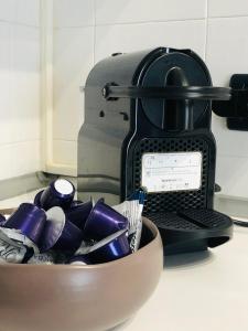 a bowl of utensils in front of a coffee maker at Residenza Avogadro in Turin