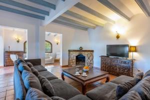 a living room with a couch and a fireplace at Casa Rosalia in Jávea