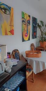 a dining room with a table and paintings on the wall at Villa Veronika in Lądek-Zdrój