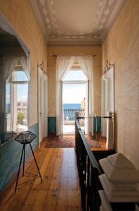 a large room with a view of the ocean at Hotel Ploes in Ermoupoli