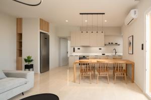 a kitchen and living room with a table and chairs at Casa delle Palme in Rethymno Town
