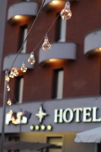 a hotel sign with lights in front of a building at Poli Hotel in San Vittore Olona