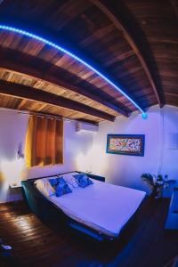 a bedroom with a bed with a blue light at Bungalow de Nola in Le Lamentin