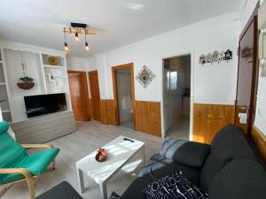 a living room with a couch and a table at Casa Make in Málaga