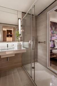 a bathroom with a glass shower and a sink at Pestana Douro Riverside - Preferred Hotels & Resorts, Lifestyle in Porto