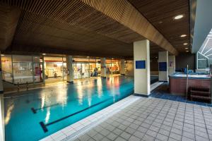 a swimming pool inside of a building at Rydges Canberra in Canberra