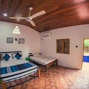 a bedroom with a bed and a ceiling fan at Wild Wadi Wilpattu in Wilpattu