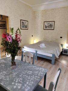 ein Zimmer mit einem Bett und einem Tisch mit Blumen darauf in der Unterkunft St. Peter's Rooms Rome in Rom