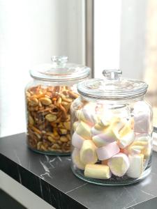 two glass jars filled with different types of nuts at Hot Spot - Premium Loft - Sanador Victoriei in Bucharest