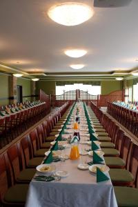 a long table in a room with red chairs at Impresja in Borek Wielkopolski