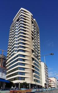 a tall white building with many windows at Apartamento com Vista para a Baía de Luanda in Luanda