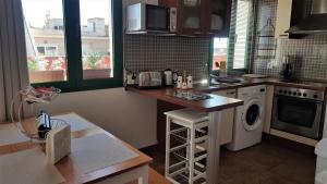 kuchnia z blatem, pralką i suszarką w obiekcie PALAZZO VIVALDI - VERIALEX ACCOMMODATION w mieście Roquetas de Mar
