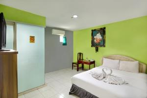 Voodi või voodid majutusasutuse Negara Hotel - CHSE Certified toas