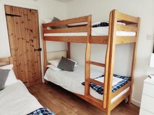 a bedroom with a bunk bed and a desk at Ocean Surf lodge in Newquay