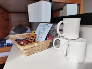 a basket of food and a coffee mug on a table at Ocean Surf lodge in Newquay