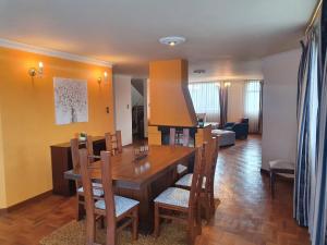 a dining room and living room with a table and chairs at MONTELUX Apartamento in La Paz