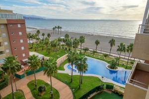 a view of the beach from the balcony of a resort at 2 bedrooms appartement at Roquetas de Mar 10 m away from the beach with sea view shared pool and furnished terrace in Roquetas de Mar