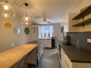 a kitchen with a large counter top in a room at Les Cerisiers The Cherry Trees in Flic-en-Flac