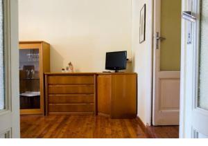 a room with a dresser with a television on it at WISTERIA HOUSE in Brunate