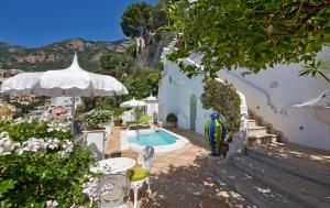 a balcony with a swimming pool and white buildings at Villa Boheme Exclusive Luxury Suites in Positano
