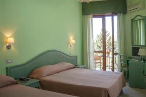 Postel nebo postele na pokoji v ubytování Hotel Orion