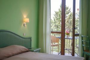 Postel nebo postele na pokoji v ubytování Hotel Orion