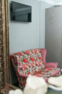 a couch sitting in front of a mirror at Villa Petit in Jeffreys Bay