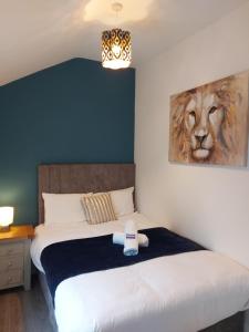 a bedroom with a bed with a lion painting on the wall at 4 Eyre Square Lane in Galway