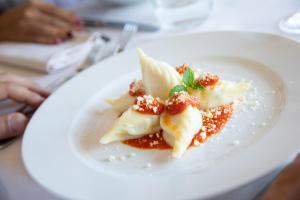 un piatto bianco con un dessert su un tavolo di Hotel la Torre a Bari Sardo