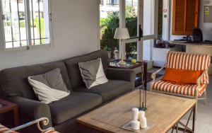 a living room with a couch and a coffee table at Villa Alexia - APARTMENT ATOLÓN - Puerto Pollensa in Port de Pollensa