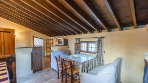 a kitchen and dining room with a table and chairs at Molino Los Justos - Cocineta Algarinejo by Ruralidays in Algarinejo