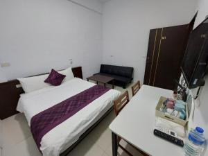 Un ou plusieurs lits dans un hébergement de l'établissement Taitung Tourist Inn