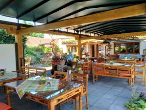 a restaurant with wooden tables and wooden chairs at Schlossberghof Marzoll in Bad Reichenhall