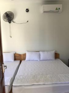Postel nebo postele na pokoji v ubytování Hoàng Sang
