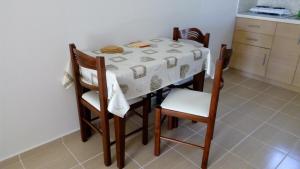 a dining room table and chairs with a white table cloth at Sivota Casa Cleopatra in Syvota