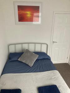 a bedroom with a bed with a pillow on it at Beach cottage in Gorleston-on-Sea