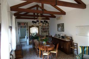 a dining room with a wooden table and chairs at Casa Colleoni in Venice