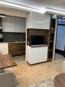 a living room with a tv on a white cabinet at Aleksinac in Aleksinac