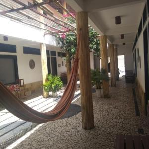 a hammock in the middle of a building at EDEN Pousada in Lagoinha