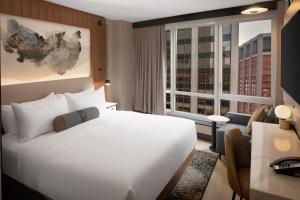 a hotel room with a large bed and a large window at Hotel Indigo - NYC Downtown - Wall Street, an IHG Hotel in New York