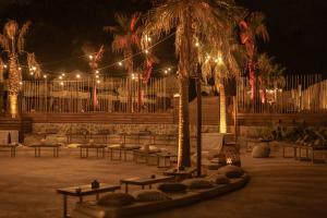 a patio with a bunch of chairs and lights at Maya Beach Resort in Massa Lubrense