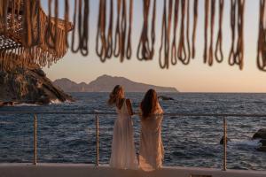 two women standing on a boat looking out at the ocean at Maya Beach Resort in Massa Lubrense